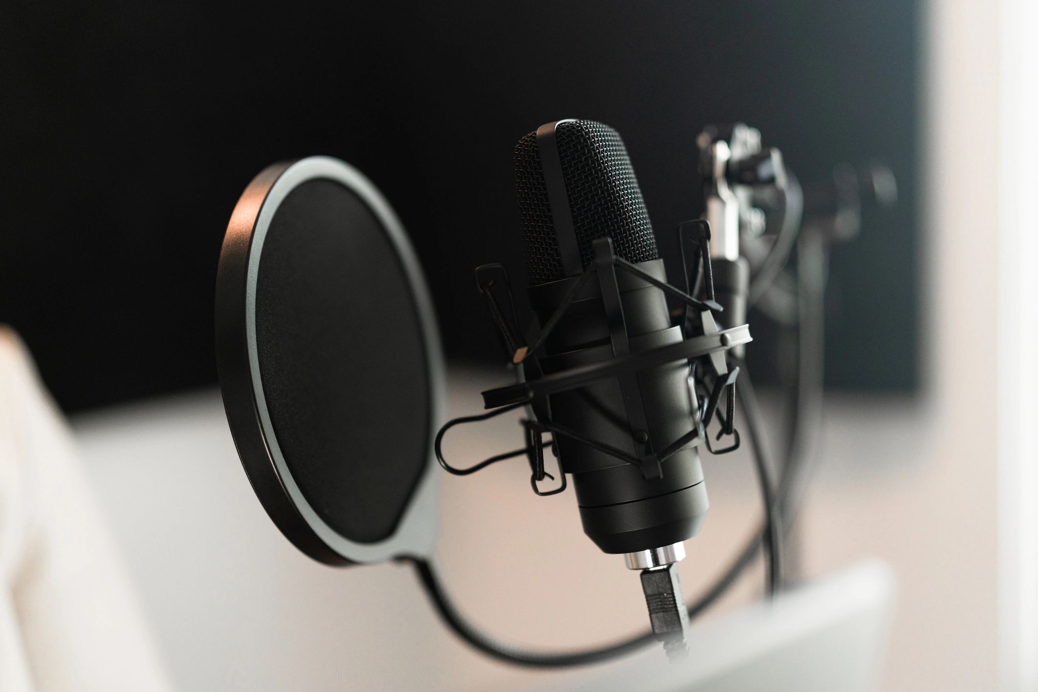 Voice actor recording at a home studio desk