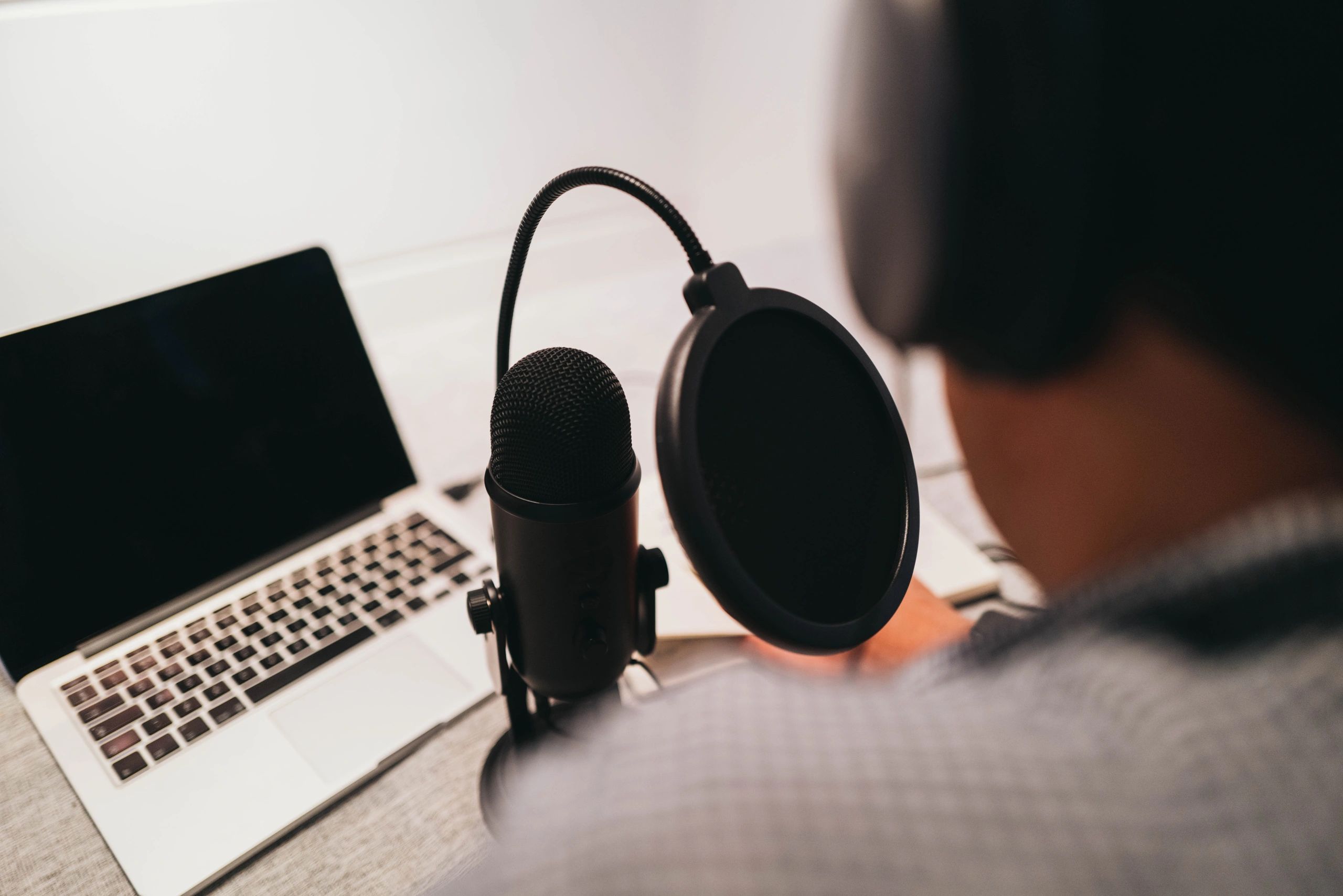 Professional voice actor speaking into a microphone for commercial voiceover